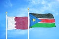 Qatar and South Sudan two flags on flagpoles and blue cloudy sky
