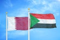 Qatar and Sudan two flags on flagpoles and blue cloudy sky