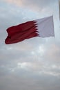 The Qatari flag hangs on the iron pole and flies in the wind during the Qatari National Day celebrations in Darb Al Saai, Qatar