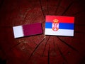 Qatari flag with Serbian flag on a tree stump isolated