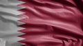 Qatari flag waving in the wind. Close up of Qatar banner blowing soft silk