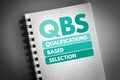 QBS - Qualifications Based Selection acronym on notepad, business concept background