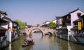 Qibao, Shanghai,China - April 7,2012:Qibao water village, boats in the main canal and an old bridge.