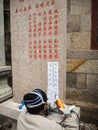 Older man carving a stele