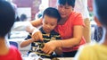 Qingyuan, China - June 23, 2016: Grandmother is teaching grandson to cook chinese traditional food zhongzi Royalty Free Stock Photo