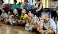 Qingyuan, China - June 23, 2016: A group of children and parents are listening to the teacher in a classroom at the kindergarten