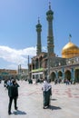 Qom, Iran - 04.20.2019: Believers walking under minarets in the courtyard of Fatima Masumeh Shrine. Hazrat Masumeh Holly Shrine