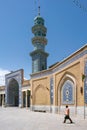 Qom, Iran - 04.20.2019: Believers walking under minarets in the courtyard of Fatima Masumeh Shrine. Hazrat Masumeh Holly Shrine