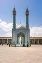 Qom, Iran - 04.20.2019: Believers walking under minarets in the courtyard of Fatima Masumeh Shrine. Hazrat Masumeh Holly Shrine