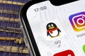 QQ messenger application icon on Apple iPhone X smartphone screen close-up. QQ messenger app icon. Social media network