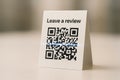 Qr code card for customer review request on table Royalty Free Stock Photo
