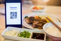 QR code tag on smartphone with blurry japanese food and dessert in restaurant to accepted generate digital pay