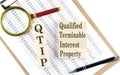 QTIP Qualified Terminable Interest Property text on wooden block on a chart background Royalty Free Stock Photo