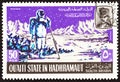 QU`AITI STATE IN THE HADHRAMAUT - CIRCA 1967: A stamp printed in Yemen shows Astronaut taking measurements on the moon, circa 1967