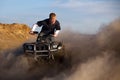 Quad ATV kicking up dust Royalty Free Stock Photo