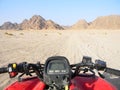 Quad bike in the desert race. All terrain vehicle or quadricycle view in the desert road. Royalty Free Stock Photo