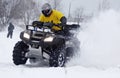 The quad bike driver rides over snow track Royalty Free Stock Photo