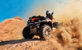 Quad bike in dust cloud, sand quarry on background Royalty Free Stock Photo