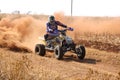 Quad Bike kicking up trail of dust on sand track during rally ra