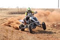 Quad Bike kicking up trail of dust on sand track during rally ra