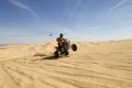 Quad Bike Rider Doing Wheelie In Desert