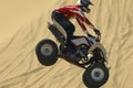 Quad bike rider in mid-air over sand Royalty Free Stock Photo