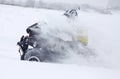 The quad bike's driver rides over snow track Royalty Free Stock Photo