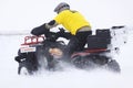 The quad bike's driver rides over snow track Royalty Free Stock Photo