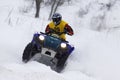 The quad bike's driver rides over snow track Royalty Free Stock Photo