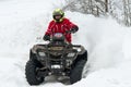 Quad bike sweeps snow