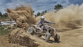 Quad bike throws up dust on a corner Royalty Free Stock Photo