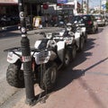 Quad bikes chained to a lamppost. Malia, Crete, Greece