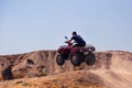 Quad bikes driver is jumping through the hill. Royalty Free Stock Photo