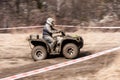 Quad competition. Man driving quad during the race among mud. Royalty Free Stock Photo