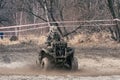 Quad competition. Man driving quad during the race among mud.