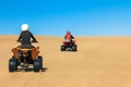 Quad driving people - two happy bikers in sand desert dunes, Africa, Namibia, Namib, Walvis Bay, Swakopmund.