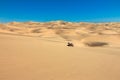 Quad driving in sand desert. ATV standing in middle of nowhere in sand dunes desert with skid marks. Africa, Namibia Royalty Free Stock Photo