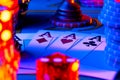 A quad of four aces, set of colored chips and dice on gaming table in casino. Playing cards, poker chips, dealer chip Royalty Free Stock Photo