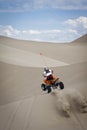 Quad rider jumping dunes Royalty Free Stock Photo