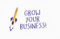 Quad or squared paper with pencil rocket and written words Grow your business