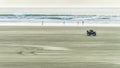 Quadbike racing down the beach Royalty Free Stock Photo