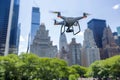 Quadcopter drone with camera flying in clear blue sky among urban skyscrapers. For themes related to surveillance Royalty Free Stock Photo