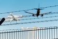 Quadcopter drone in flight close to airplane approaching airport runway Royalty Free Stock Photo