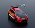 Quadcopter drone take off from electric rescue SUV on black background