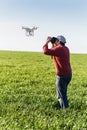 Quadcopter outdoors, aerial imagery and recreation concept - close contact between human and robot, hovering drone and