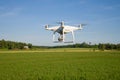 The quadcopter `Phantom 4 Edvansed` flying over the field close up Royalty Free Stock Photo