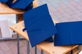 Quadrangular cap as a symbol of a graduate. Background with selective focus and copy space