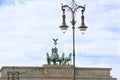 Berlin, Quadriga on Brandenburg Gate and nostaligic street lamp. Old gas lantern with wrought iron decoration. Berlin, Germany