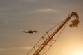 Quadrocopter drone with remote control vs Television Camera hanging on crane. Royalty Free Stock Photo