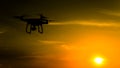 Quadrocopters silhouette against the background of the sunset. Flying drones in the